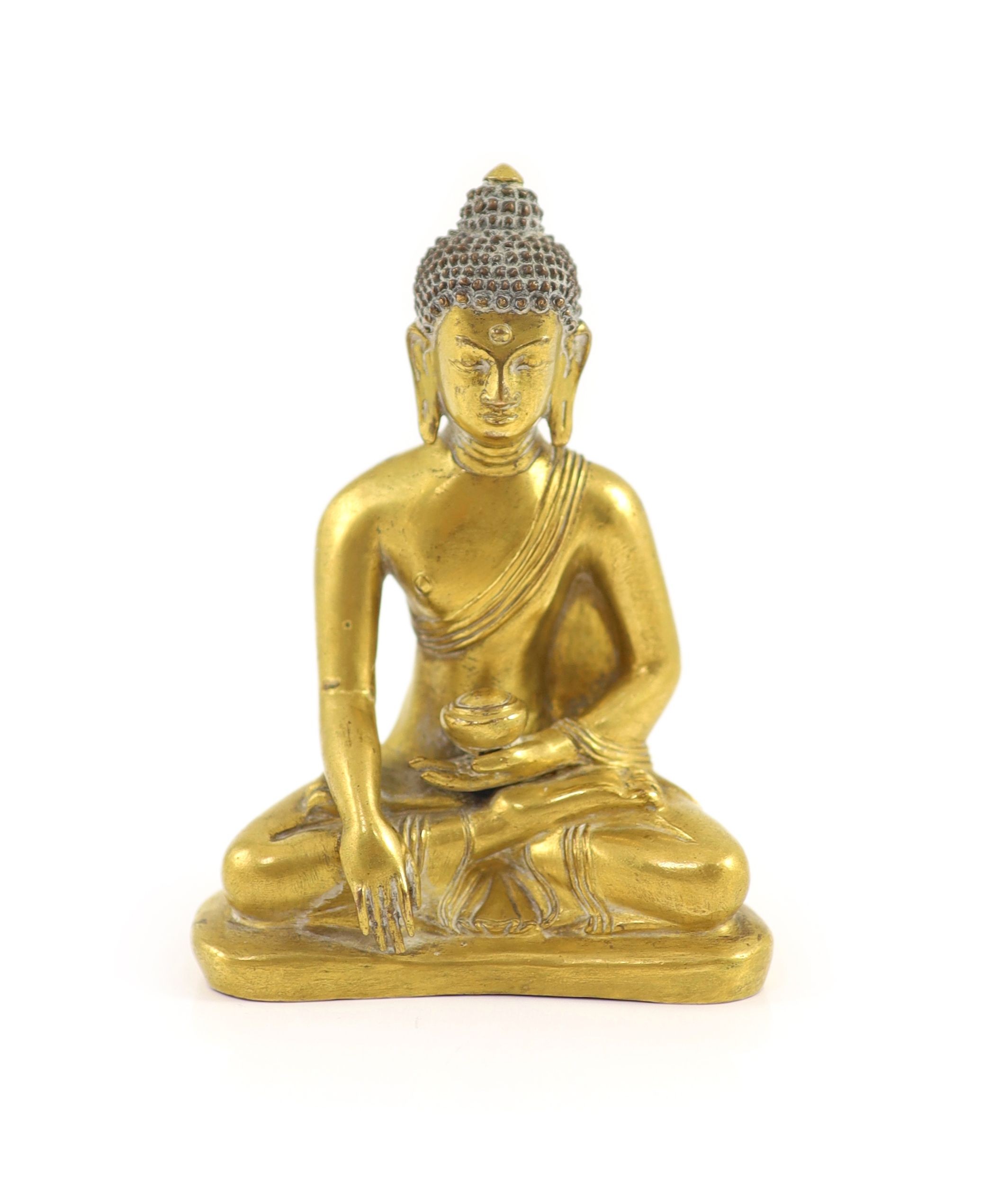 A Tibetan gilt copper alloy seated figure of Buddha Shakyamuni, 18th century, 13cm high